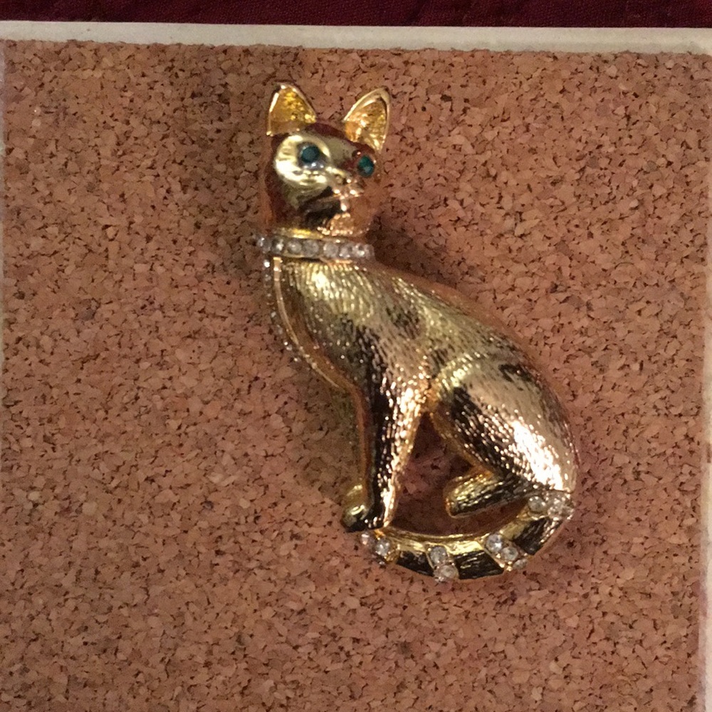 Gold cat with white and green rhinestone eyes, used